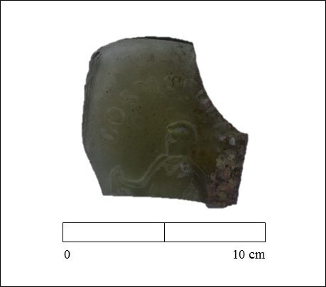 Fragment of decorated glass bottle labeled with “Cosmopo” (Credit: Lynn Harris, ECU) 