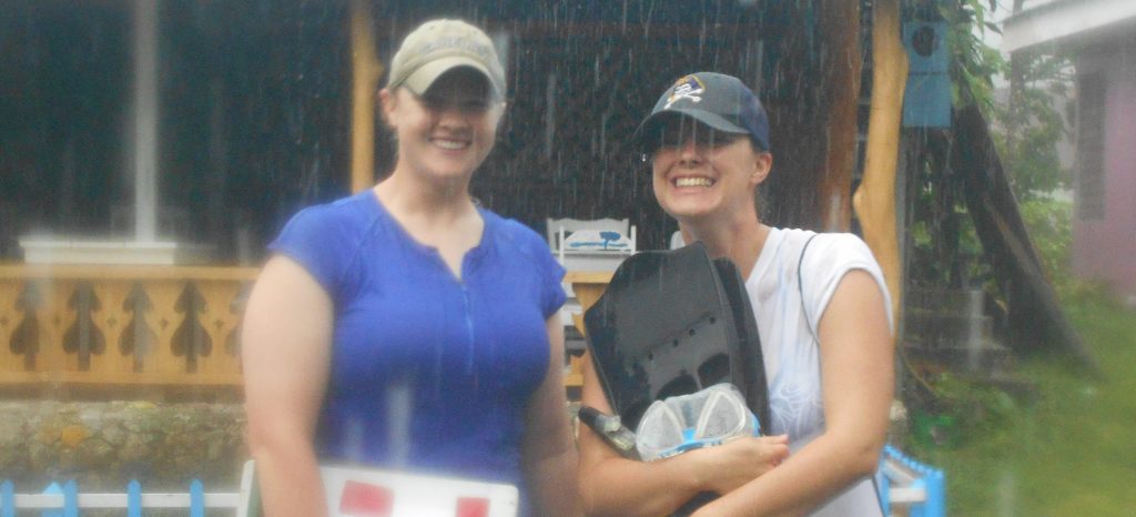 Students, Clevenger and Ropp, smile in the pouring rain
