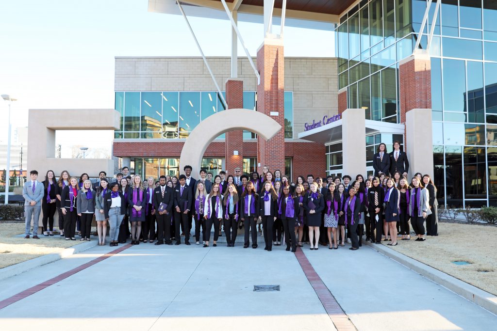 group photo of EC Scholars in front of the ECU letters at the student center