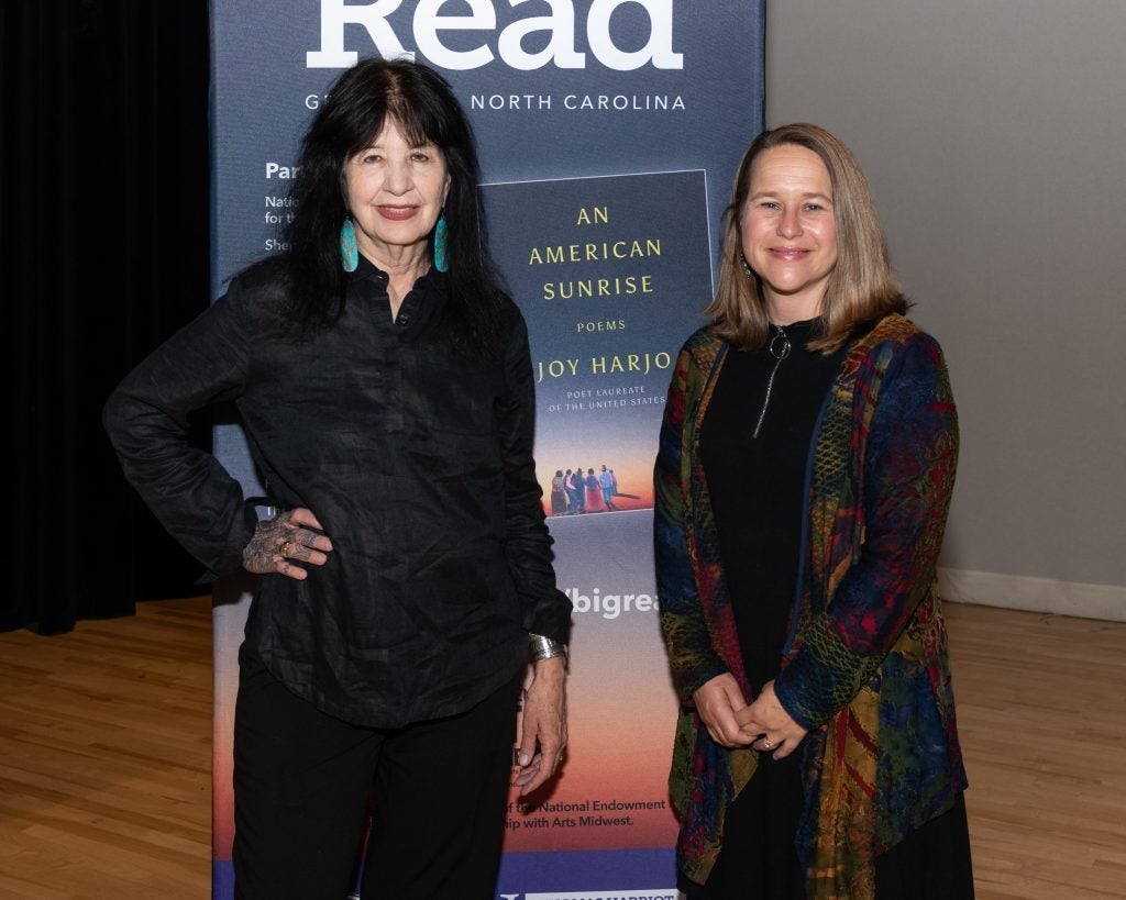 Dr. Kirstin Squint stands beside Joy Harjo at an event promoting indigenous work